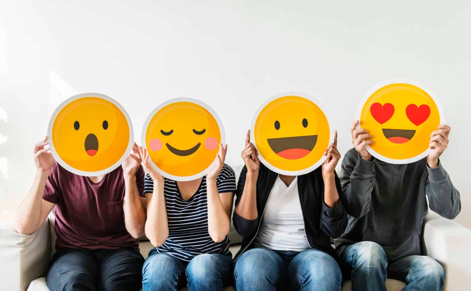 2 TSX Stocks to Purchase and 1 to Offload four people hold happy emoji masks