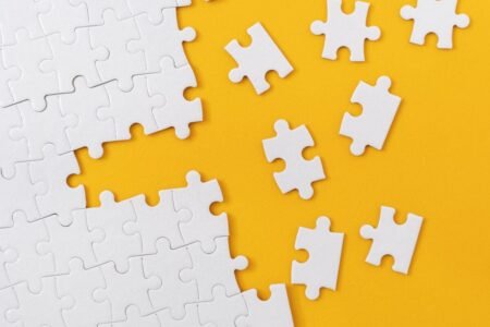 How I’m Organizing My $7,000 TFSA for Consistent Monthly Income Partially complete jigsaw puzzle with scattered missing pieces