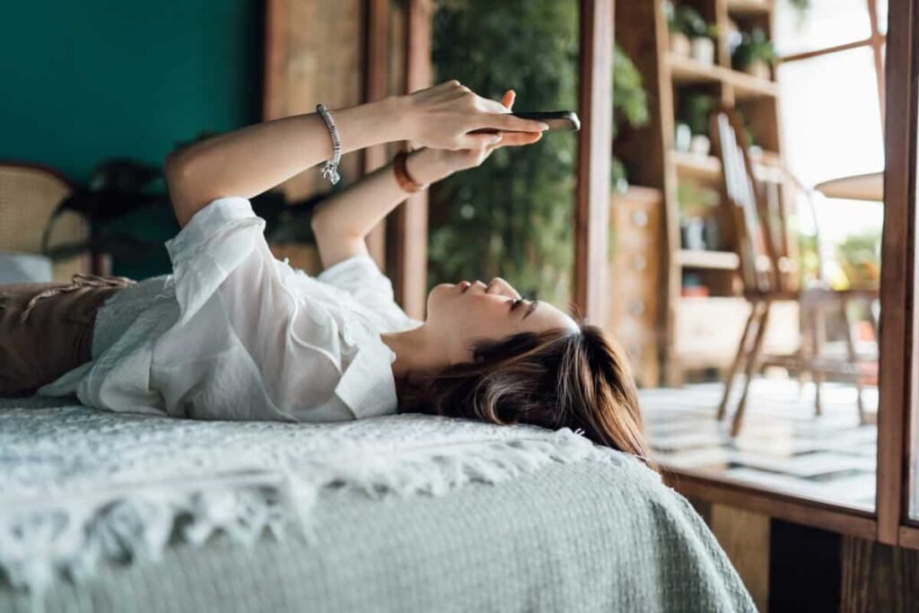 woman relaxes with phone