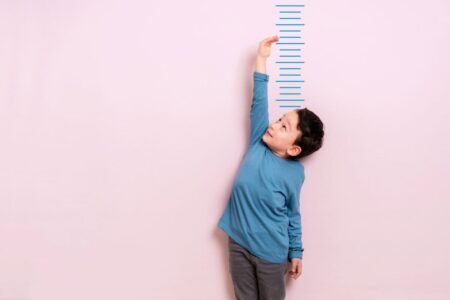 Investing in Enbridge: A 16% Dip and a 5.8% Yield Make It a Worthy Purchase Child measures his height on wall. He is growing taller.