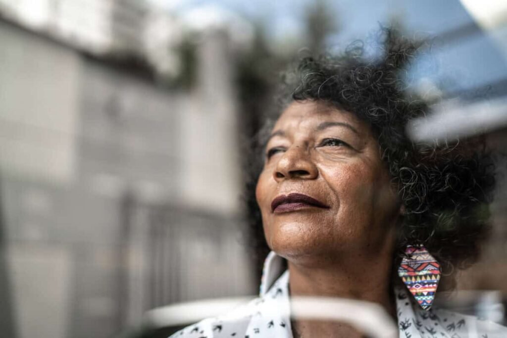 woman gazes forward out window to future
