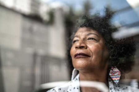 Retirement Dividend Earnings: Possible Pitfalls to Consider woman gazes forward out window to future